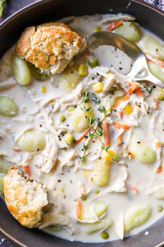 Chicken Pot Pie Soup in a grey plate with biscuits
