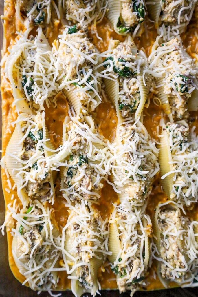 Unbaked Stuffed Pasta Shells covered in Italian Cheese