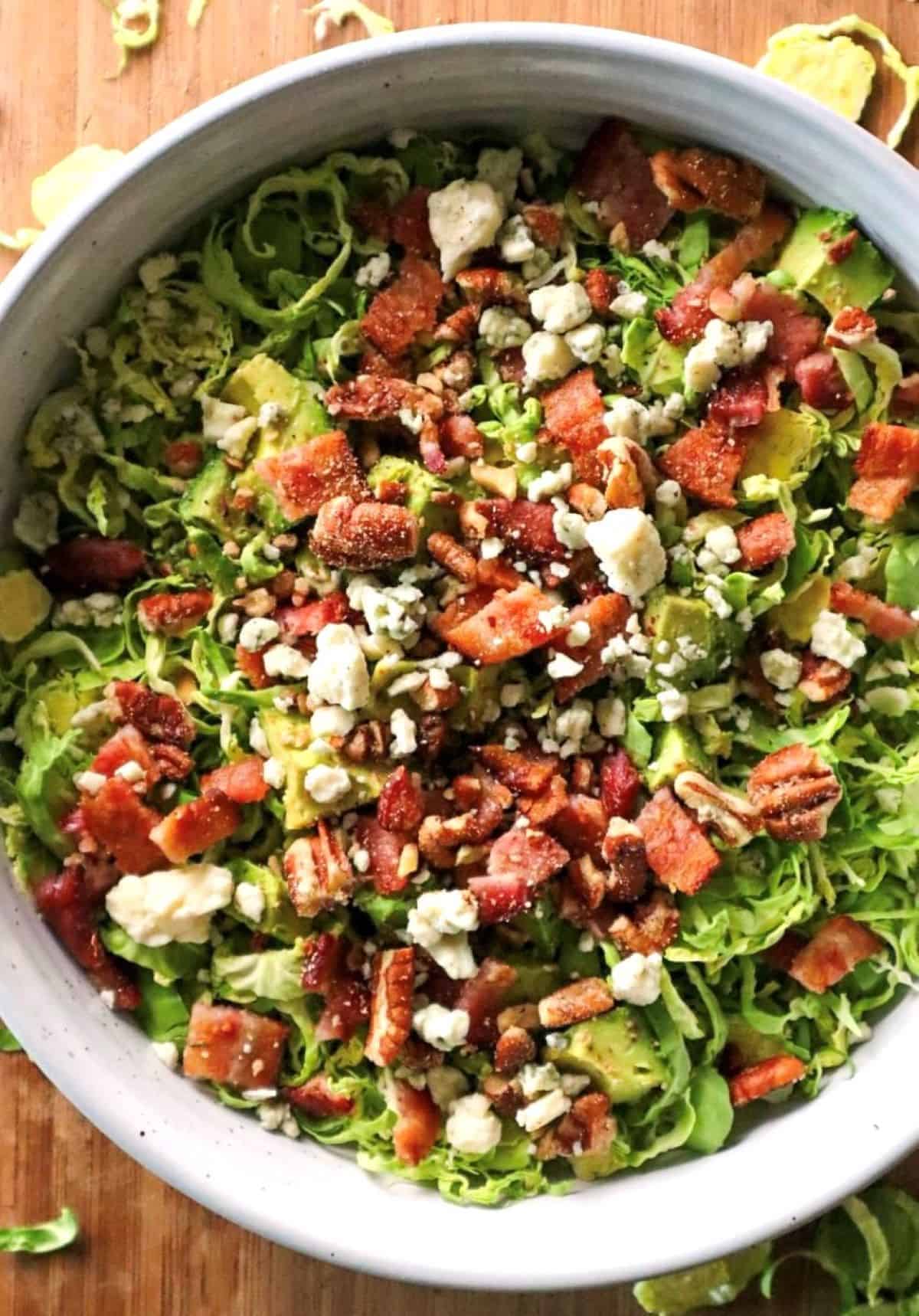 ingredients for shaved brussels sprouts salad in a white bowl
