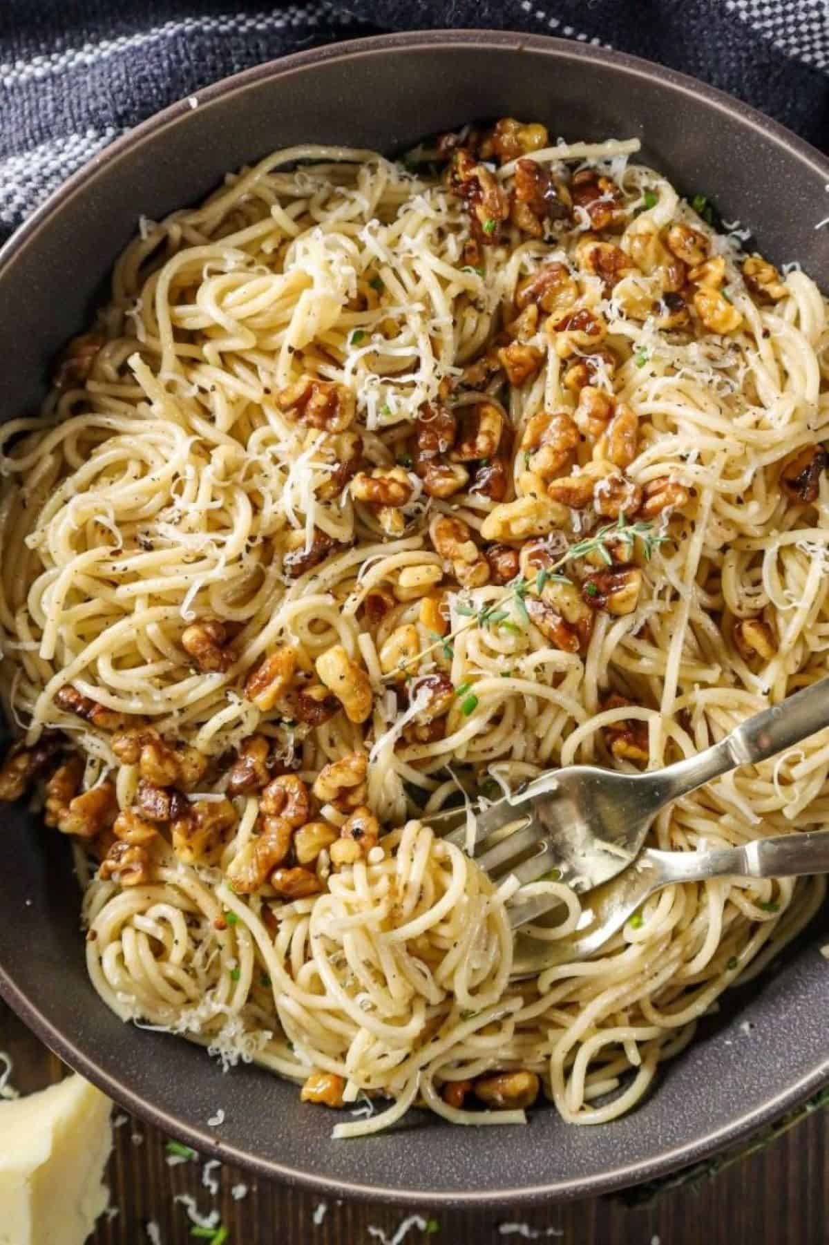 brown butter walnut pasta in gray plate