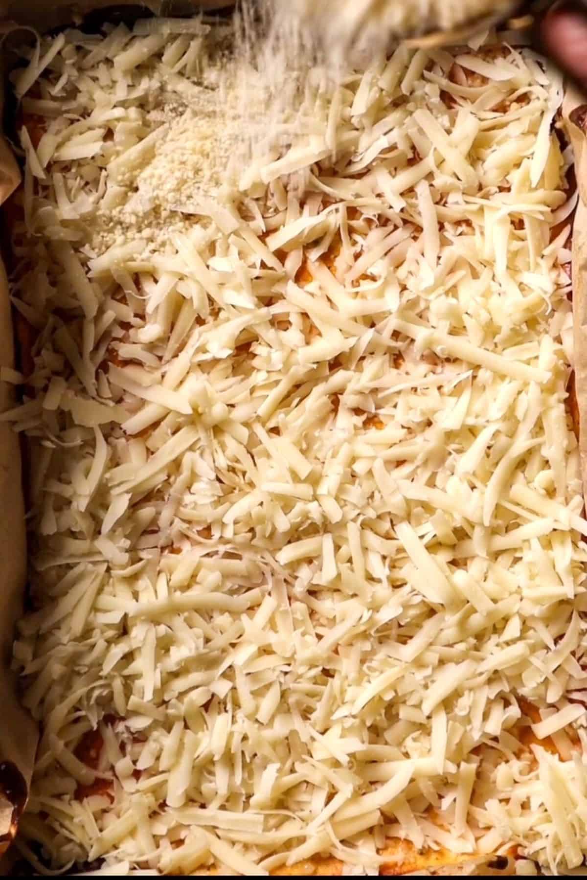 shredded mozzarella cheese on a cottage cheese crust