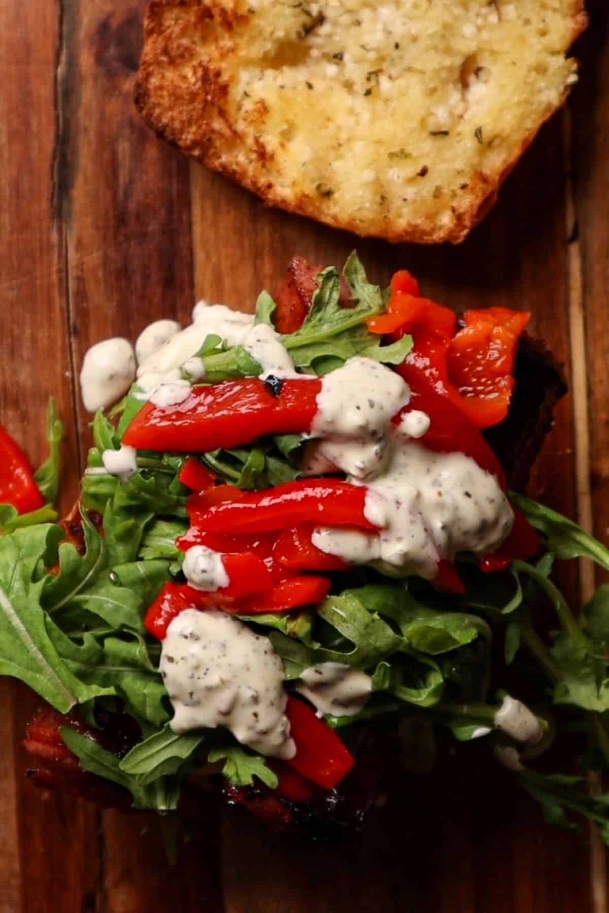 smoked sausage sandich with roasted red peppers and pesto sauce