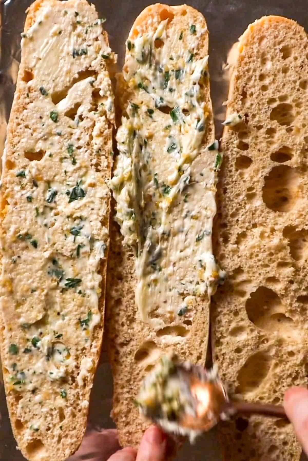 garlic herb butter smeared onto french bread